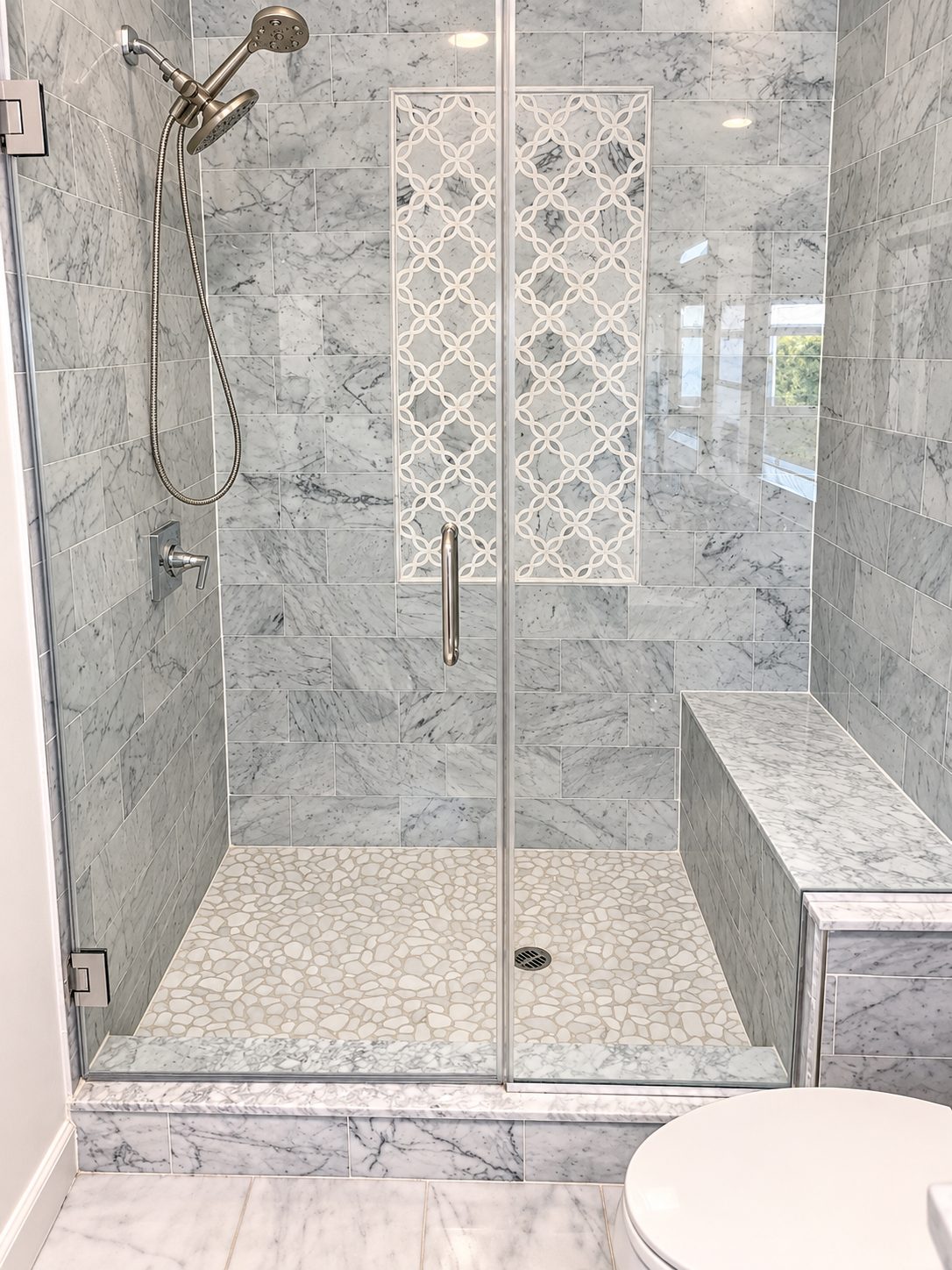 Carrara subway tile shower with mosaic feature panel and bench