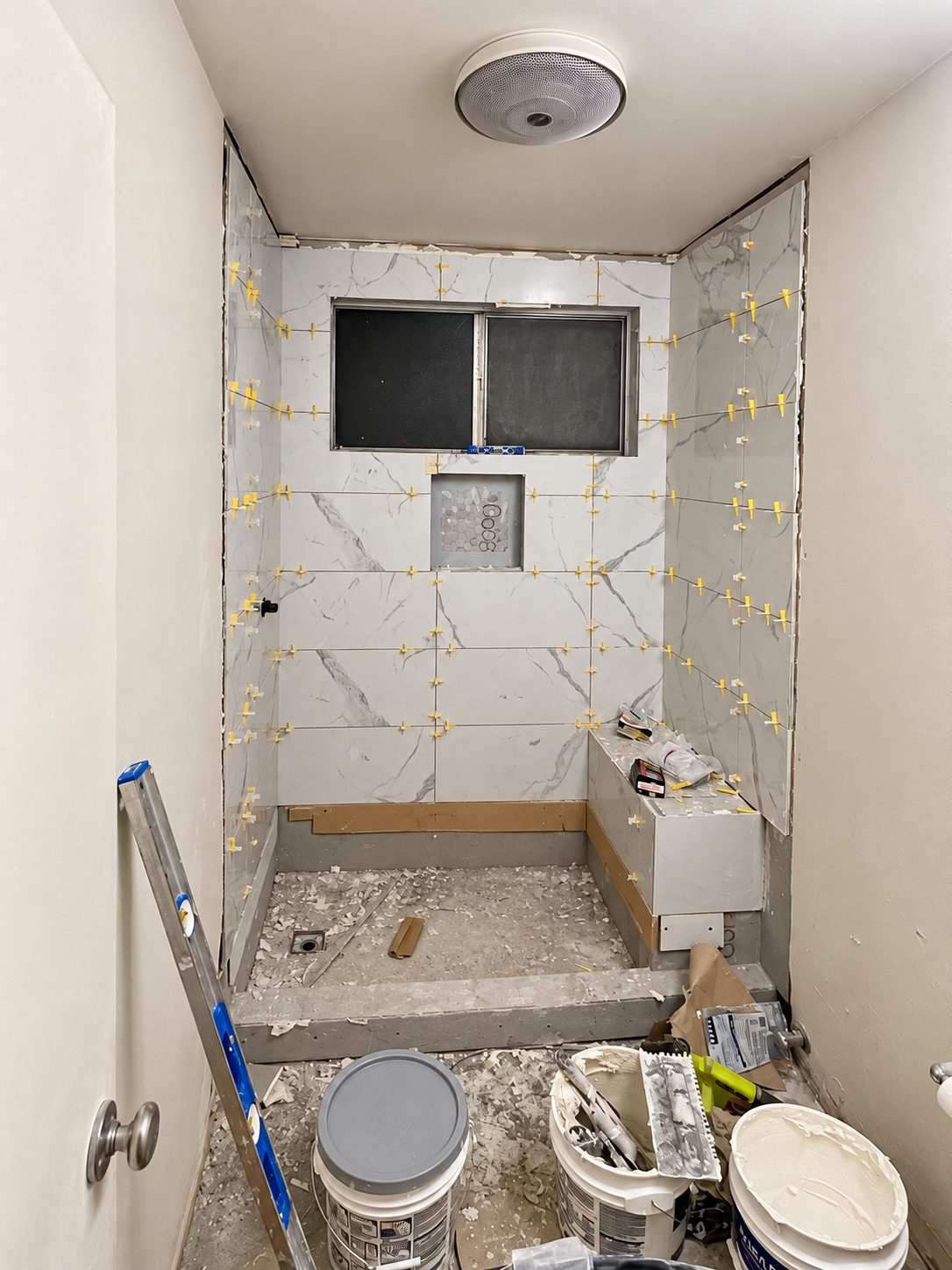 Tile being set with leveling clips