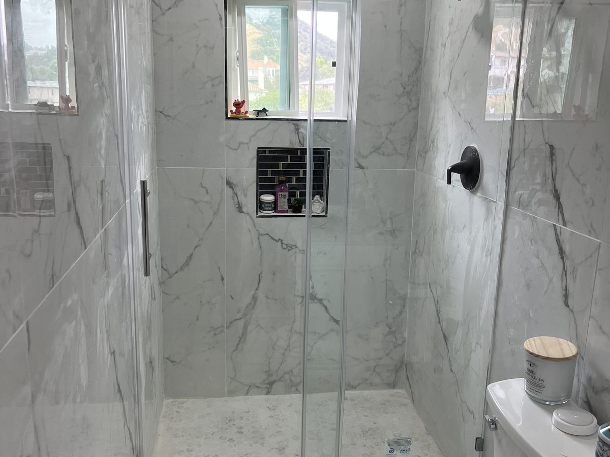 Large-format marble-look tile in a walk-in shower