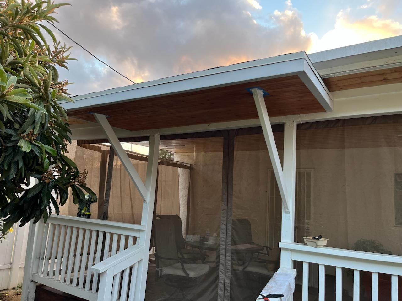 Wood patio cover with white posts and cedar ceiling