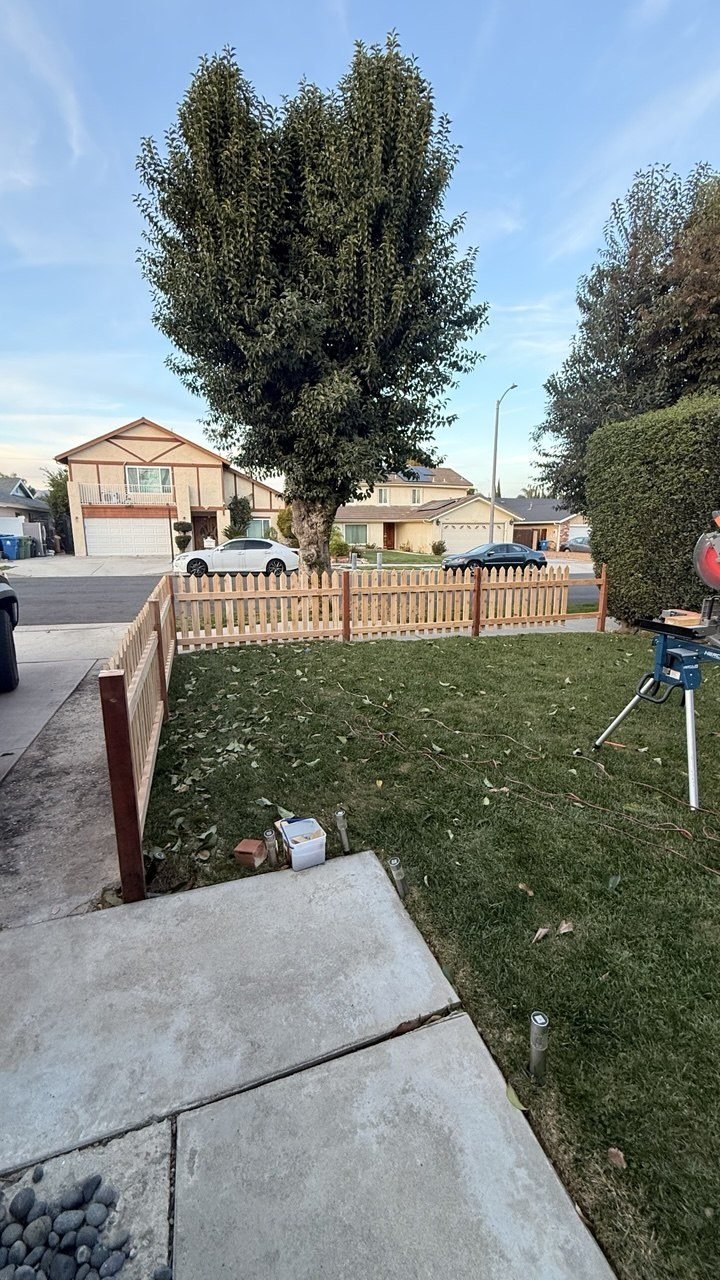 Natural wood picket fence on a corner lot