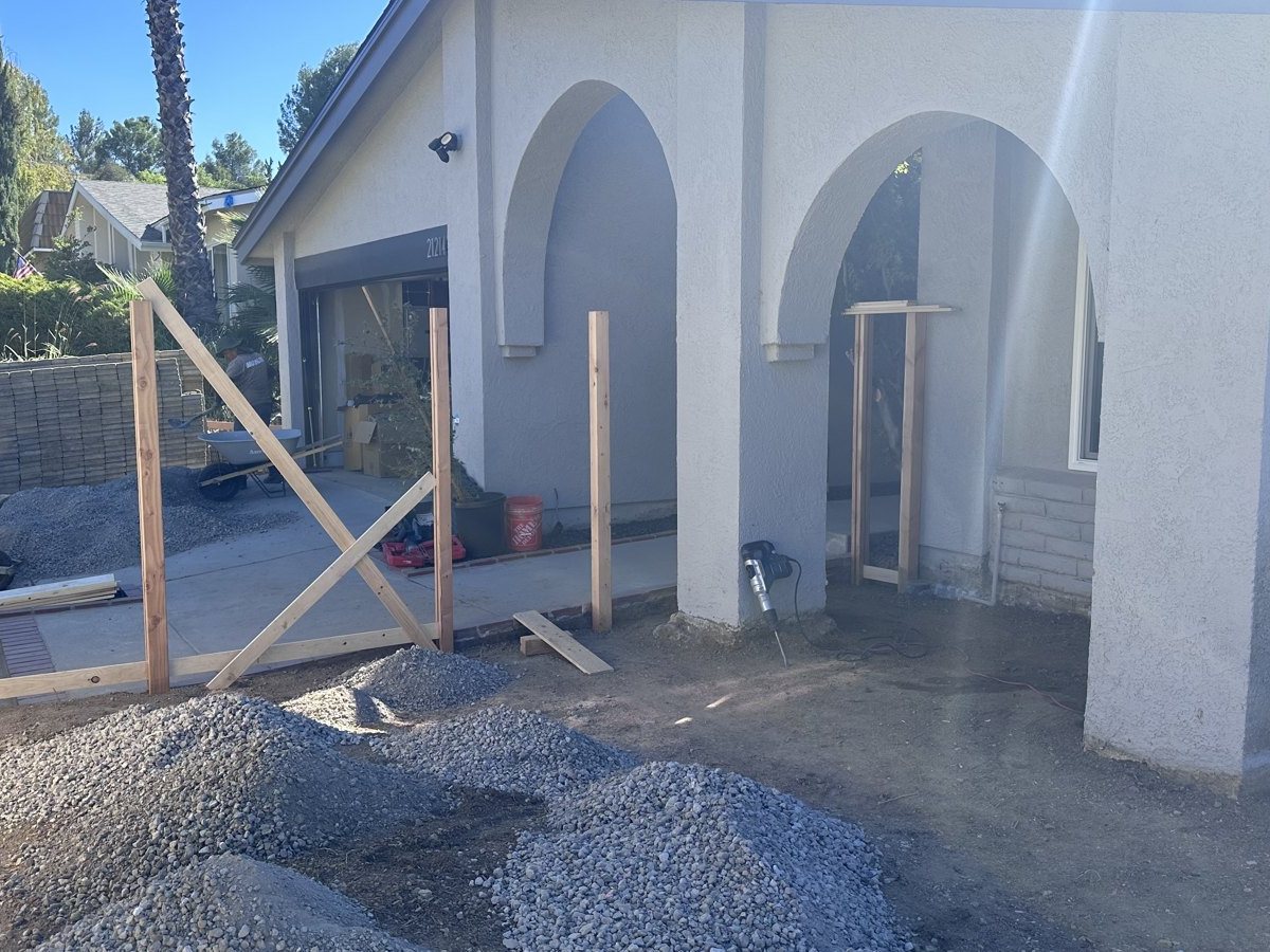 New fence posts set in concrete along the driveway before the boards go on